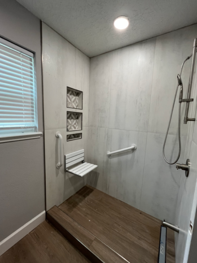 Accessible walk-in shower remodel with grab bars and folding seat